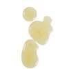 Golden liquid body oil swatch drops showing lightweight product texture.