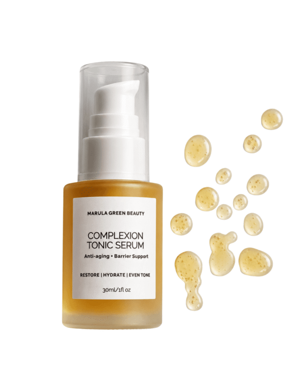 Marula Green Beauty Complexion Tonic Serum bottle alongside golden liquid serum droplets on a white background.
