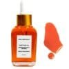 Fade Face Oil antioxidant powerhouse serum bottle alongside rich orange oil liquid swatch.