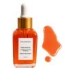 Fade Face Oil antioxidant powerhouse serum bottle alongside rich orange oil liquid swatch