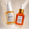 Two 30ml skincare bottles from Marula Green Beauty floating mid-air surrounded by glowing liquid splashes and droplets. On the left is the Complexion Tonic Serum in a frosted glass pump bottle; on the right is the Fade Face Oil in an amber glass bottle with a gold dropper top.