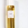 Marula Green Beauty Glow Reset Toner bottle filled with golden toner, photographed against a white background with visible bubbles and droplets of toner beside it.