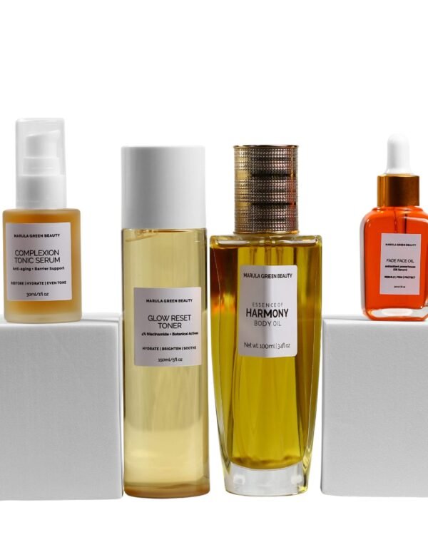 Marula Green Beauty The Complete Ritual set — Complexion Tonic Serum (30ml) and Fade Face Oil (30ml) raised on white pedestals, framing the Glow Reset Toner (150ml) and Essence of Harmony Body Oil (100ml) at centre, against a white background.